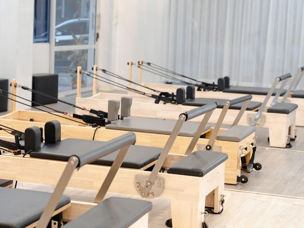 Modern minimalist gym interior with high quality equipment and calm lighting.